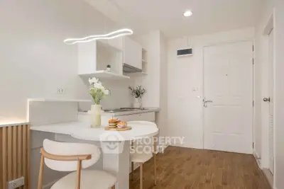 Modern kitchen with sleek design, open layout, and stylish lighting in a cozy apartment.