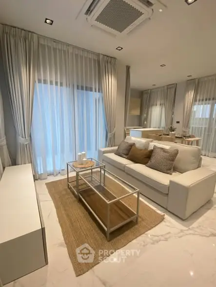 Luxurious modern living room with elegant decor and large windows