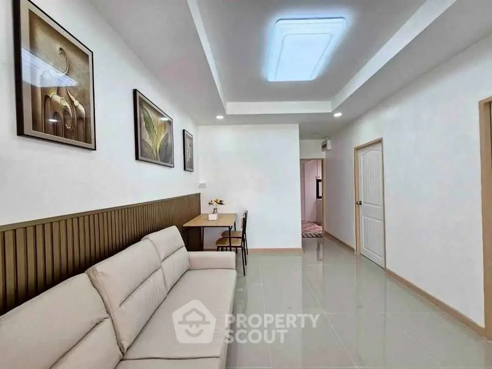 Modern living room with sleek design, comfortable sofa, and elegant wall art in a bright, inviting space.