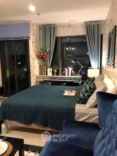 Luxurious bedroom with elegant decor and city view, featuring plush furnishings and ambient lighting.