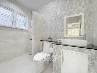 Modern bathroom with stylish tiles and sleek fixtures in a bright, airy space.