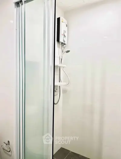 Modern bathroom with sleek shower enclosure and white tiles