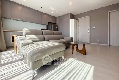 Spacious modern living room with sleek furniture and ample natural light