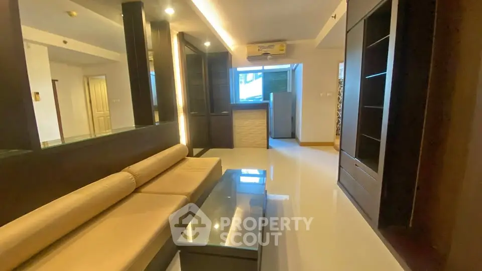 Spacious modern living room with sleek furniture and ambient lighting