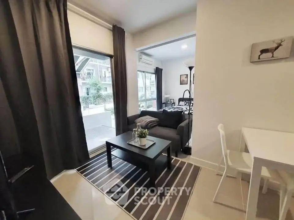 Modern living room with stylish decor and large windows in a contemporary apartment.