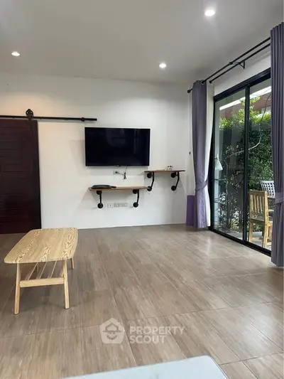 Spacious living room with modern decor and garden view