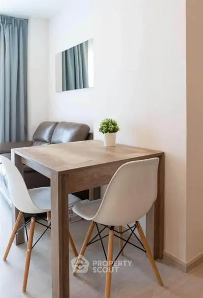 Modern living room with stylish dining area and cozy seating, perfect for urban living.