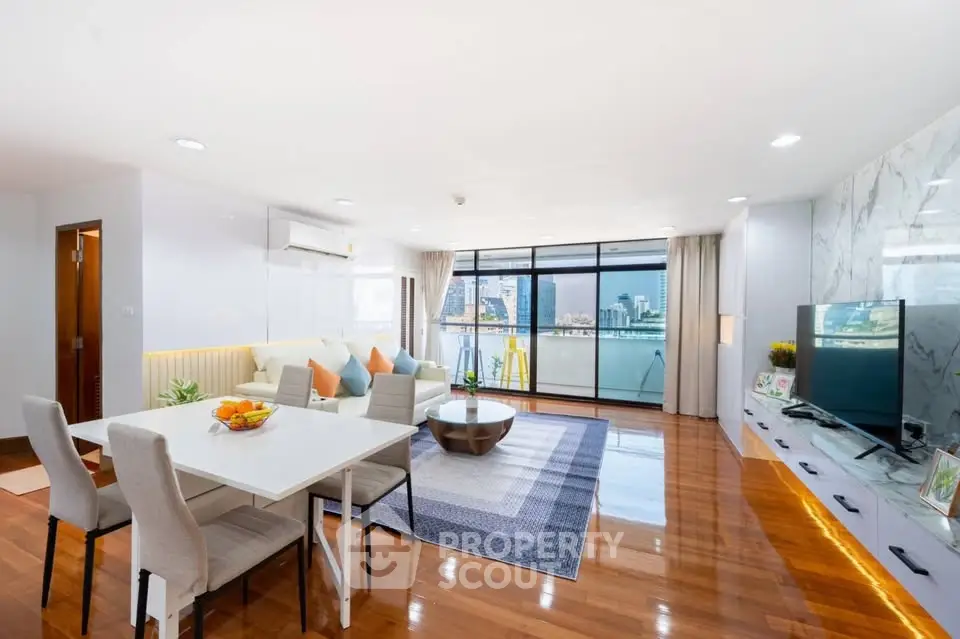 Spacious modern living room with city view, elegant decor, and natural light.