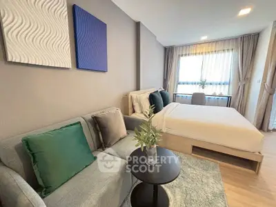 Modern bedroom with stylish decor and cozy seating area, perfect for relaxation and comfort.