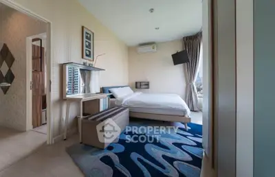 Modern bedroom with stylish decor and large window offering city views, featuring a cozy bed and contemporary furniture.