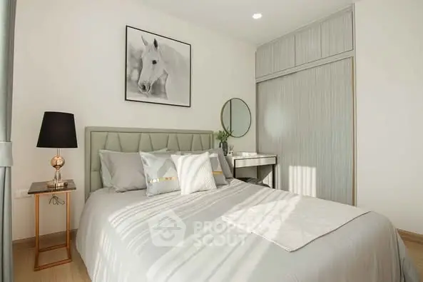 Elegant bedroom with modern decor and stylish furnishings, featuring a cozy bed and chic lighting.