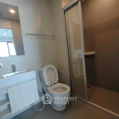 Modern bathroom with sleek fixtures and glass shower enclosure