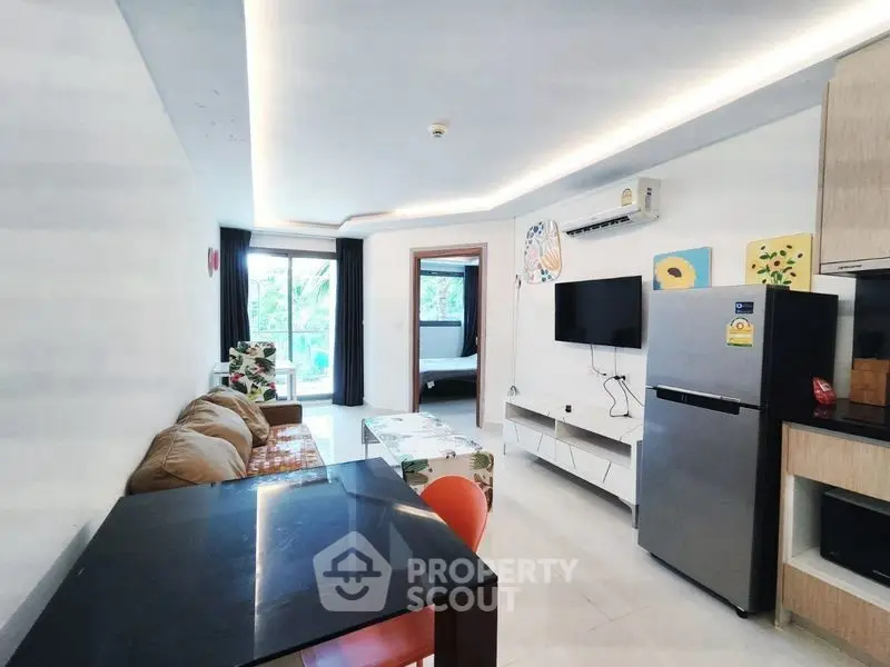 Modern living room with open layout, stylish furniture, and natural light.