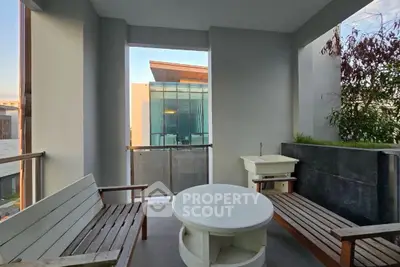 Stylish balcony with modern seating and scenic view, perfect for relaxation and entertaining.