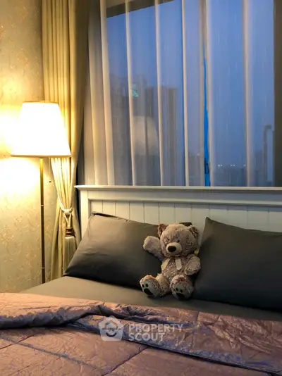 Cozy bedroom with plush teddy bear and soft lighting, perfect for relaxation.