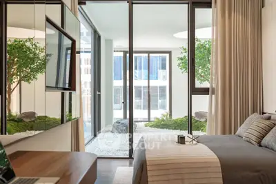 Luxurious bedroom with modern decor and garden view, featuring floor-to-ceiling windows and elegant furnishings.