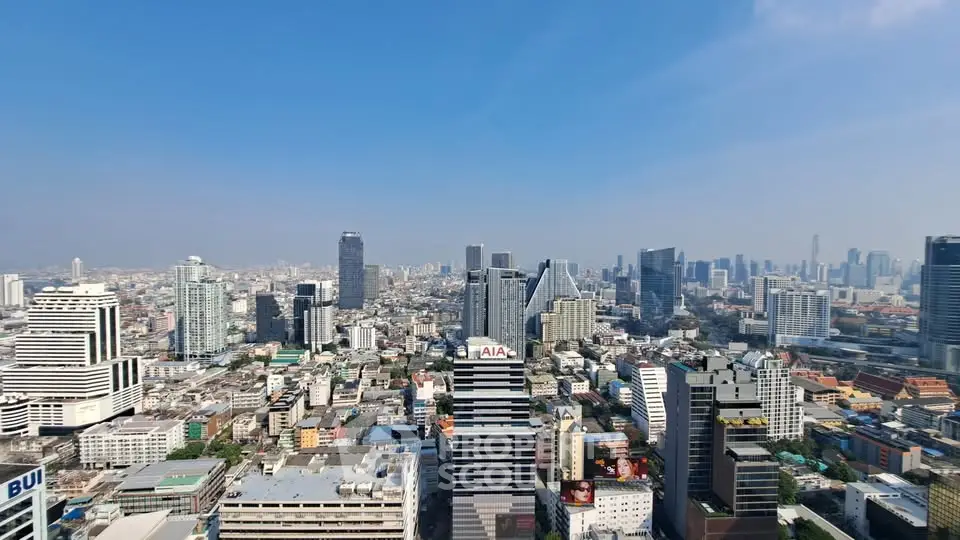 Stunning panoramic cityscape view showcasing modern skyscrapers under a clear blue sky.