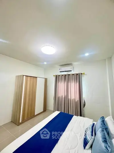 Cozy bedroom with modern decor and ample natural light