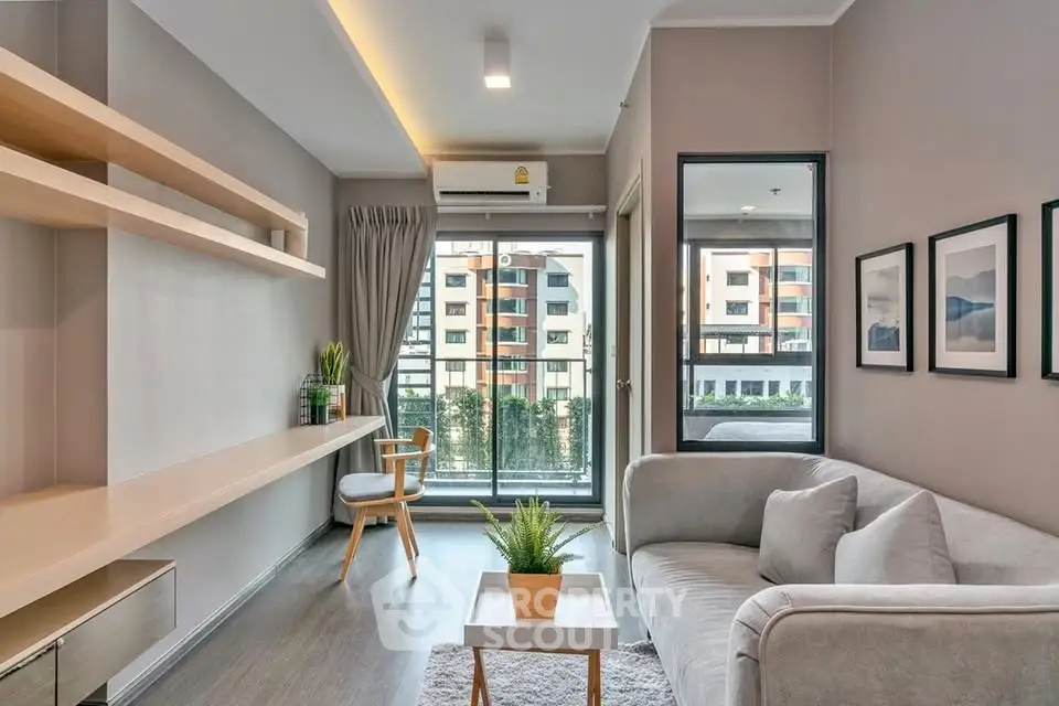 Modern living room with stylish decor and large window offering city view