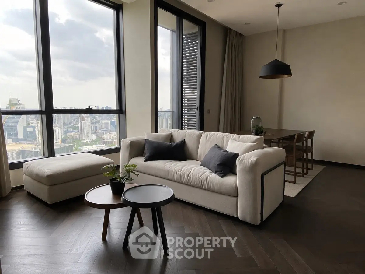 Luxurious modern living room with panoramic city view, elegant furniture, and stylish decor.