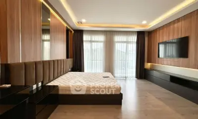 Luxurious modern bedroom with large windows and sleek wooden accents