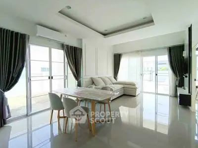 Spacious modern living room with large windows and elegant decor