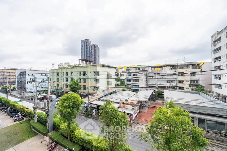 Urban cityscape view with residential buildings and lush greenery, showcasing vibrant neighborhood life.