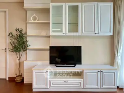 Stylish living room with modern white cabinetry and sleek TV setup