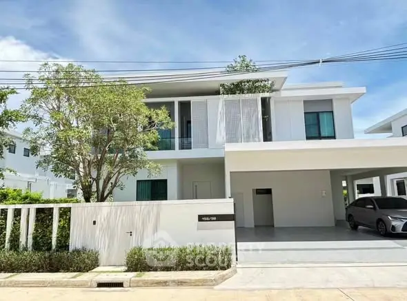 Modern two-story house with sleek design and spacious driveway in a serene neighborhood.