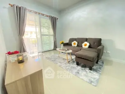 Bright living room with cozy sofa and large window for natural light