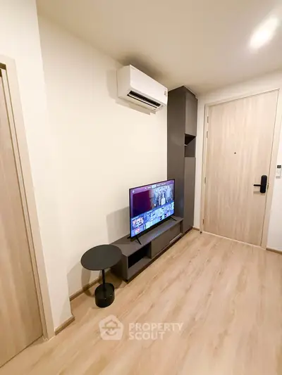 Modern living room with sleek TV setup and air conditioning