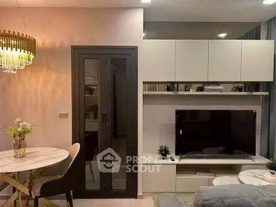 Modern living room with stylish decor, featuring a cozy seating area, elegant lighting, and a sleek entertainment center.