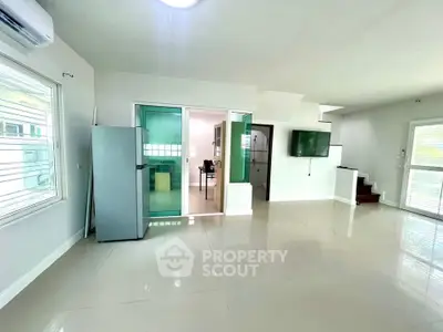 Spacious modern living area with sleek kitchen and natural light