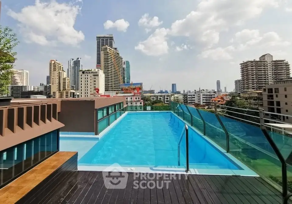 Stunning rooftop pool with panoramic city views in a modern urban setting.
