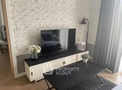 Stylish living room with modern decor and flat-screen TV, perfect for relaxation.