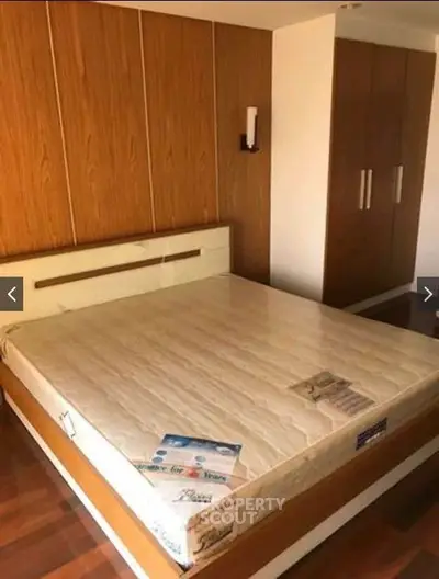 Spacious bedroom with wooden accents and built-in wardrobe
