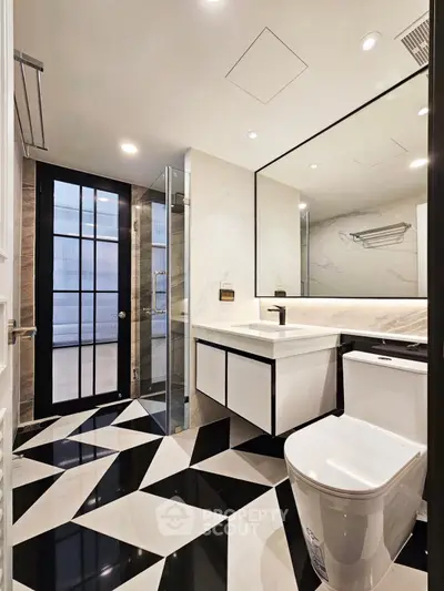 Luxurious modern bathroom with geometric floor tiles and sleek fixtures