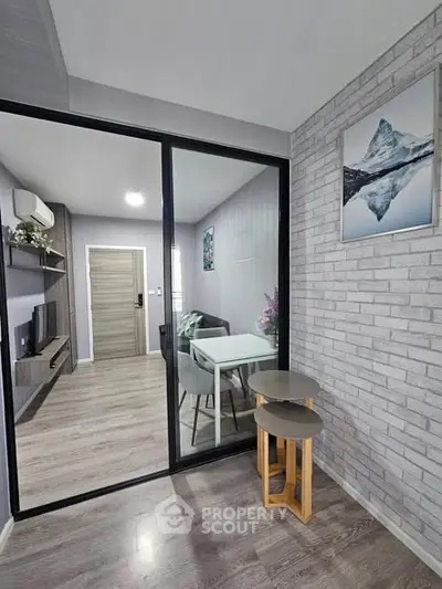 Modern living room with glass partition and stylish decor