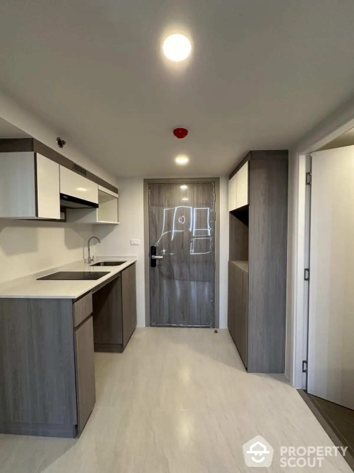 Modern kitchen with sleek cabinetry and minimalist design, featuring a closed layout and integrated appliances.