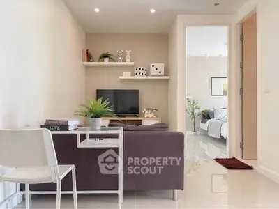 Modern living room with sleek furniture and open view to bedroom, ideal for stylish urban living.