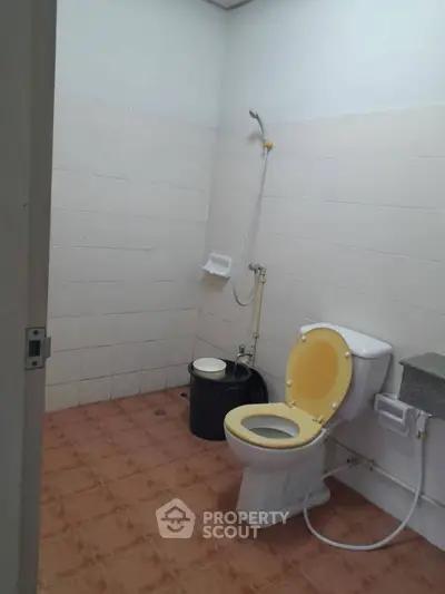 Simple bathroom with shower and toilet in a real estate property