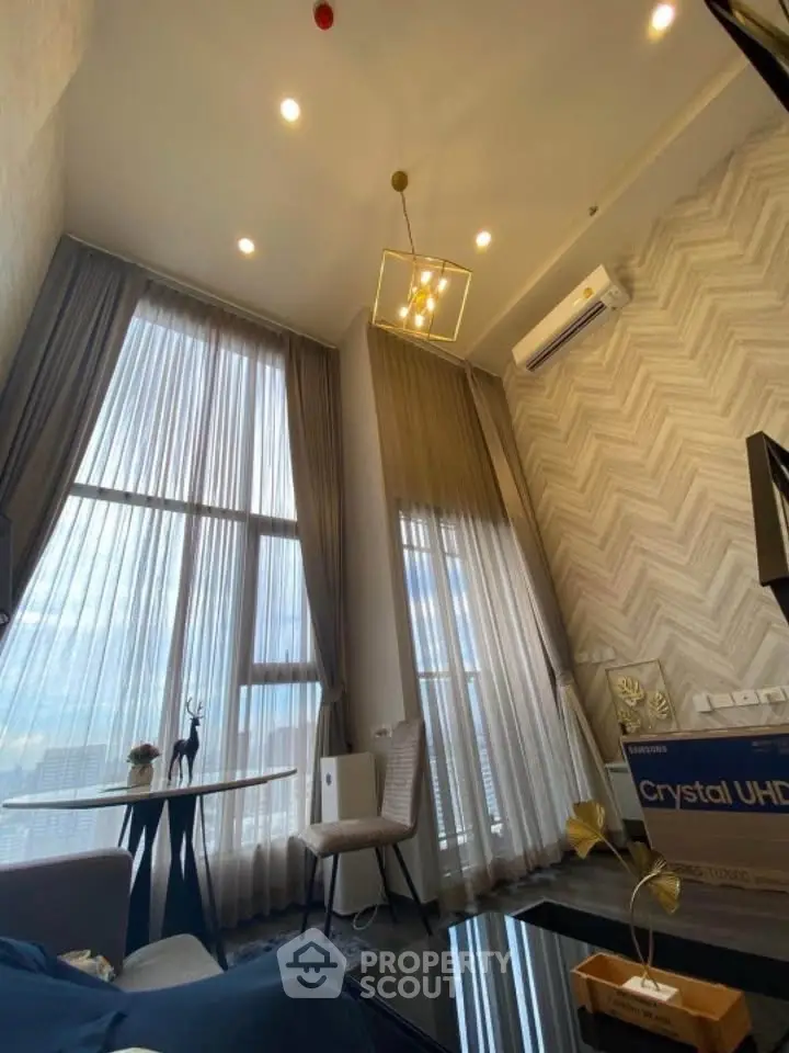 Luxurious high-ceiling living room with modern decor and large windows offering stunning views.