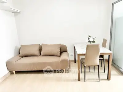 Modern minimalist living room with beige sofa and dining table, bright and inviting space.