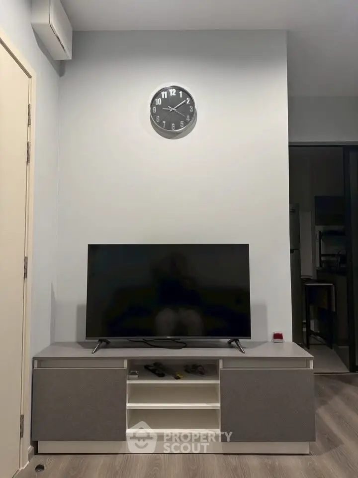 Modern living room with sleek TV setup and minimalist decor, perfect for contemporary living.