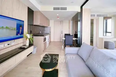 Modern living room with sleek design, open kitchen, and stylish furniture in a contemporary apartment.