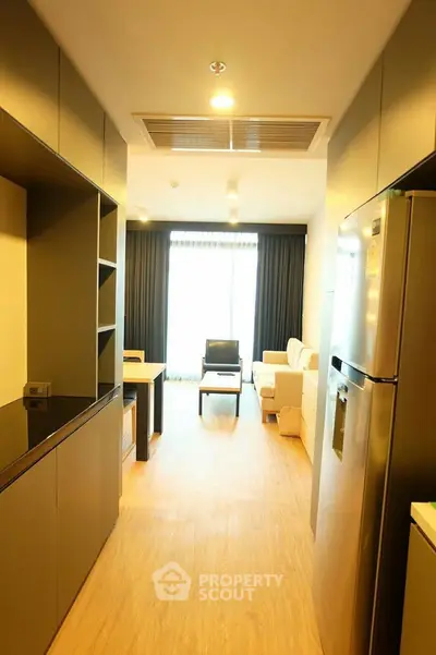Modern open-plan kitchen and living room with sleek appliances and stylish decor