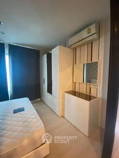 Modern bedroom with sleek furniture and air conditioning in a stylish apartment.