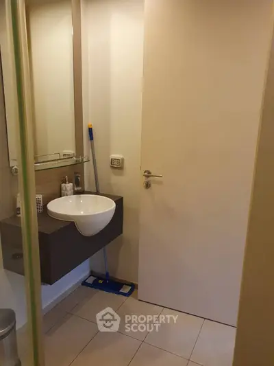 Modern bathroom with sleek sink and tiled floor