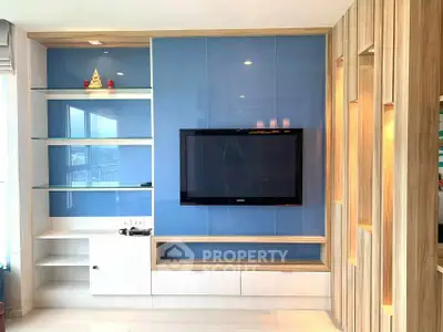 Modern living room with sleek TV unit and glass shelves