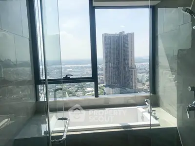 Luxurious bathroom with stunning city view from high-rise apartment window.